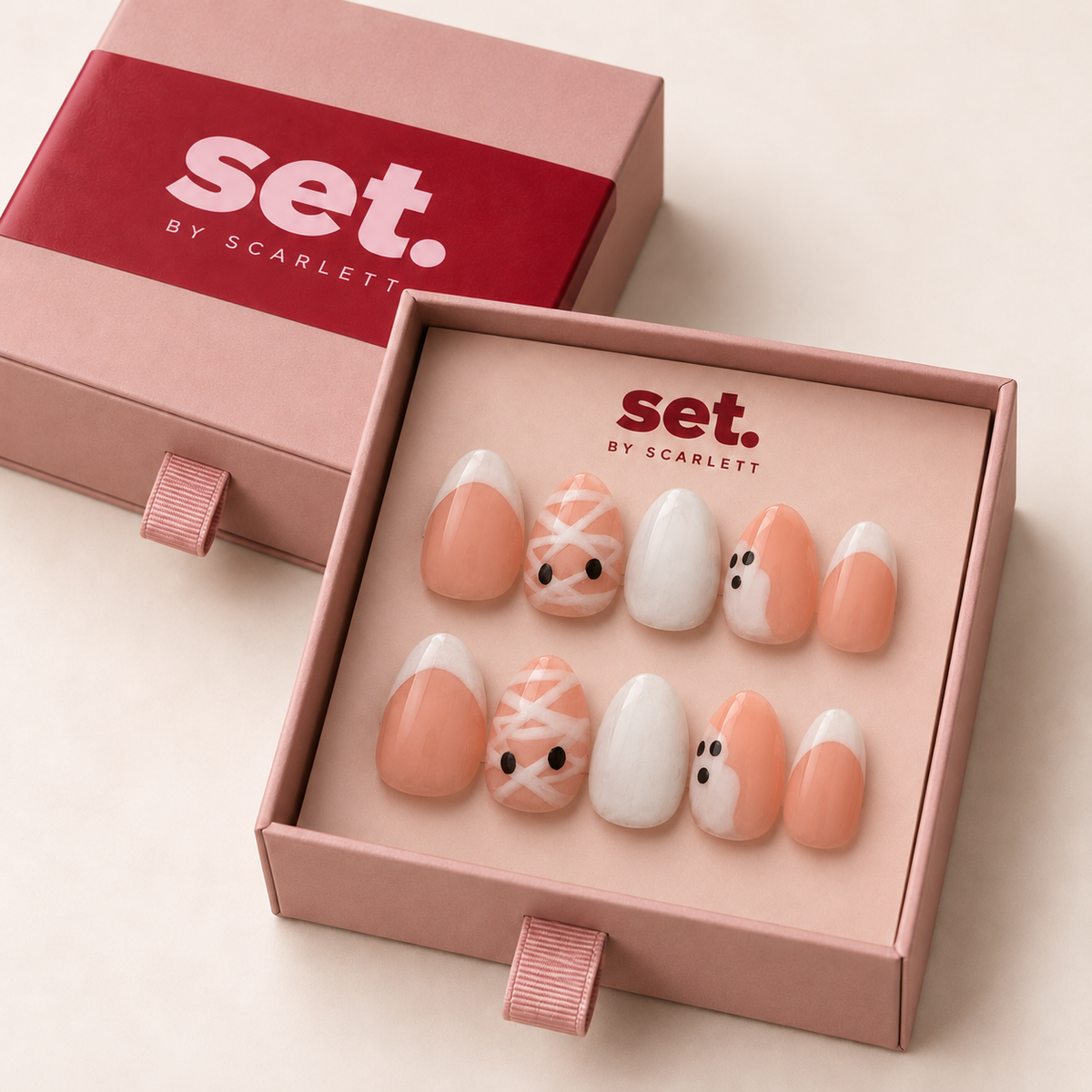 Boo Crew: White French tips, mummy stripes, ghost art and milky-white accents. Digitally styled packaging mockup based on Scarlett's photographed nail set.