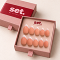 Milk Edit: White French tips over a peach-nude base. Digitally styled packaging mockup based on Scarlett's photographed nail set.