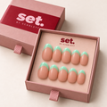 Mint Condition: Pastel mint-green French tips over a nude base. Digitally styled packaging mockup based on Scarlett's photographed nail set.