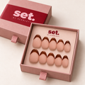 Mocha Line: Cocoa-brown French tips over a pink-nude base. Digitally styled packaging mockup based on Scarlett's photographed nail set.